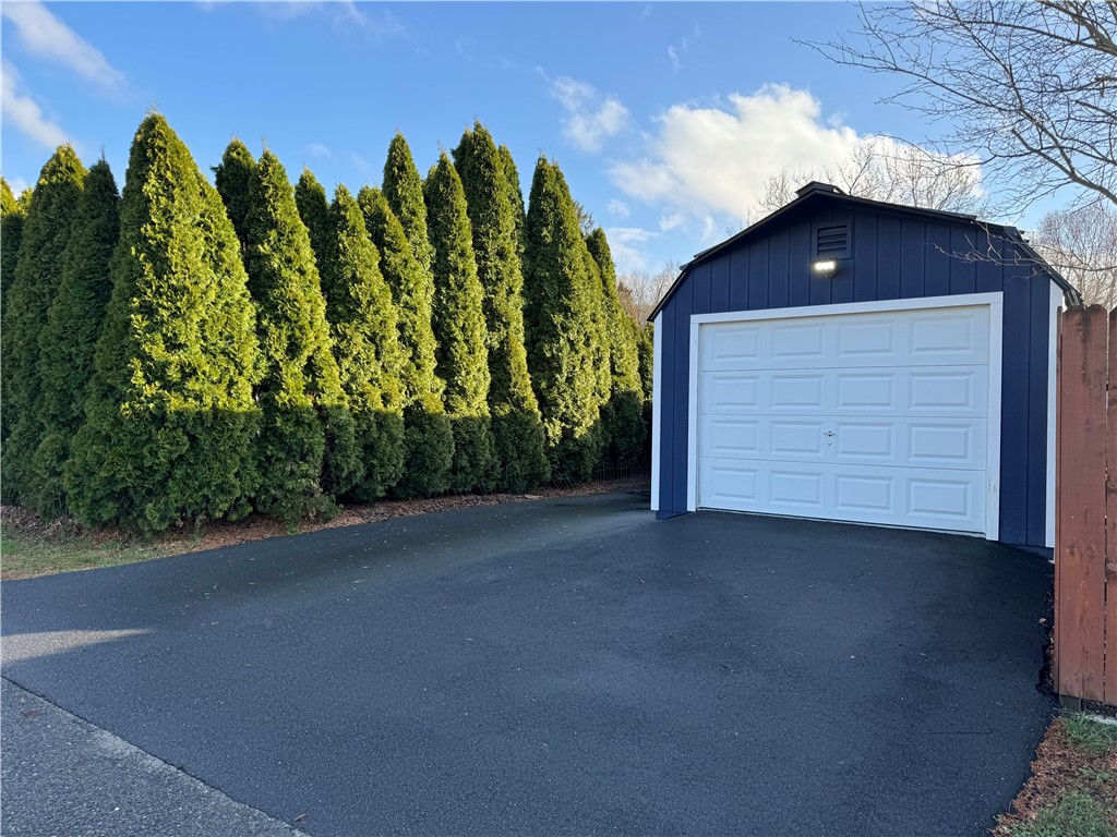 Side entrance to barn-like garage and additional parking.