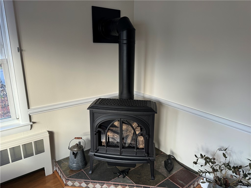122 Greenville Road North Smithfield, RI 02896 - Photo 8 of 20 Free standing fireplace keeps the living room warm and cozy.