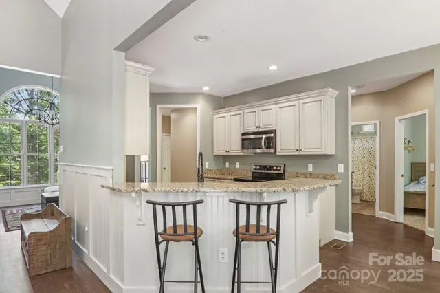 a kitchen with stainless steel appliances granite countertop a stove and a sink