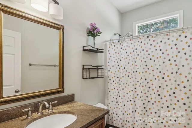 a bathroom with a sink a vanity and a mirror