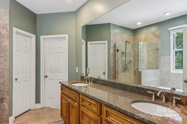 a bathroom with a double vanity sink and a mirror