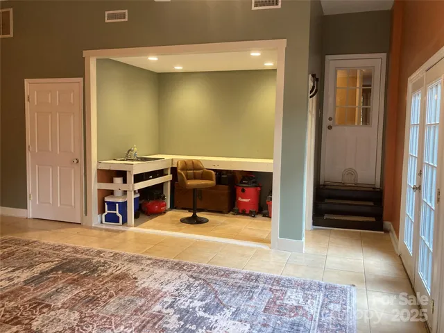 a view of a livingroom with furniture and an empty room