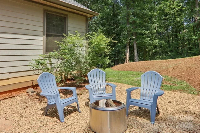 a view of a chairs and table in backyard