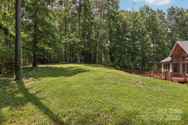 a backyard of a house with yard and trampoline