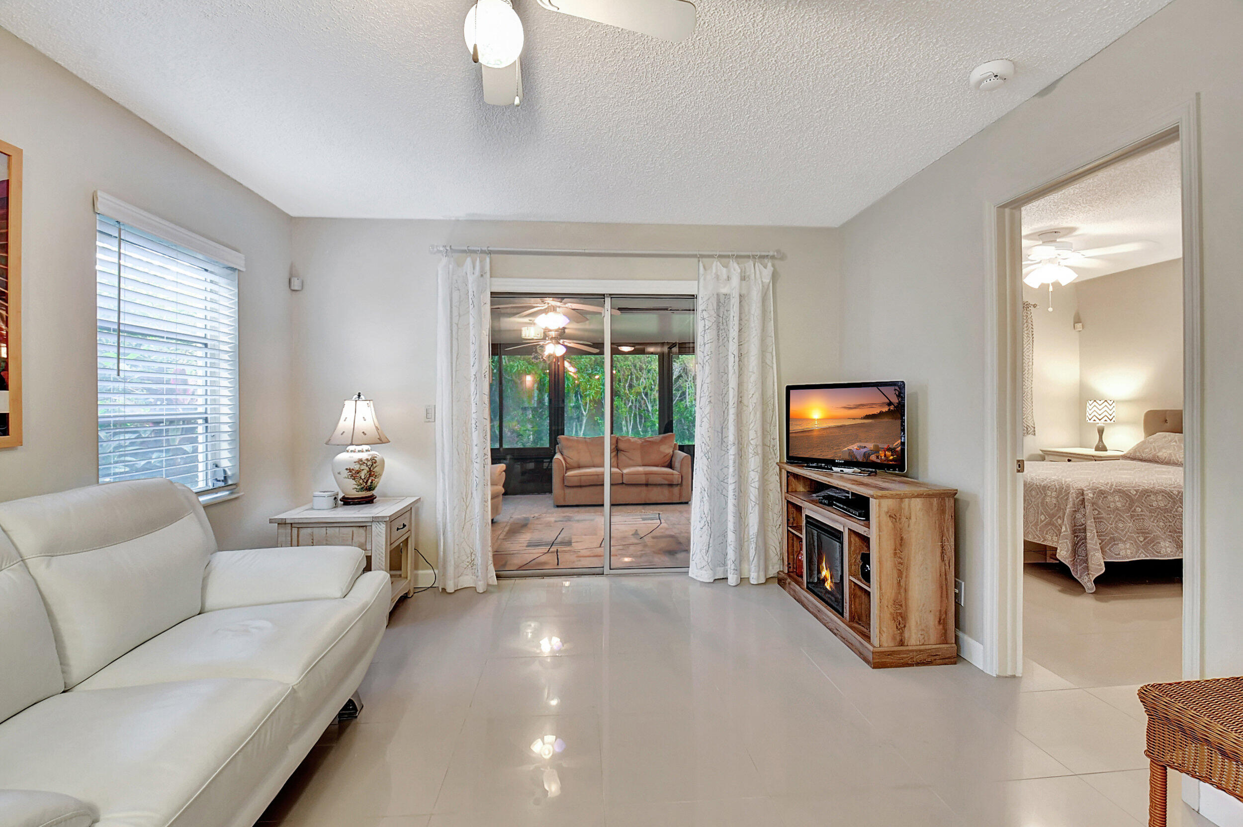 14520 Lucy Drive Delray Beach, FL 33484 - Photo 1 of 63 a living room with furniture and a flat screen tv