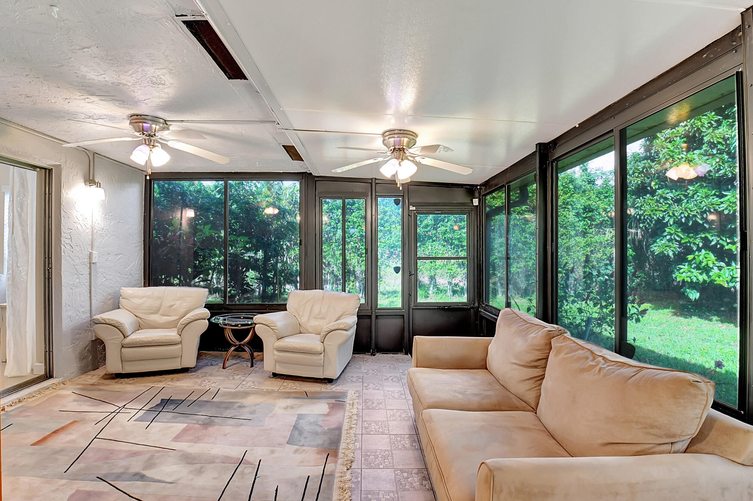 14520 Lucy Drive Delray Beach, FL 33484 - Photo 13 of 63 a living room with furniture and large windows