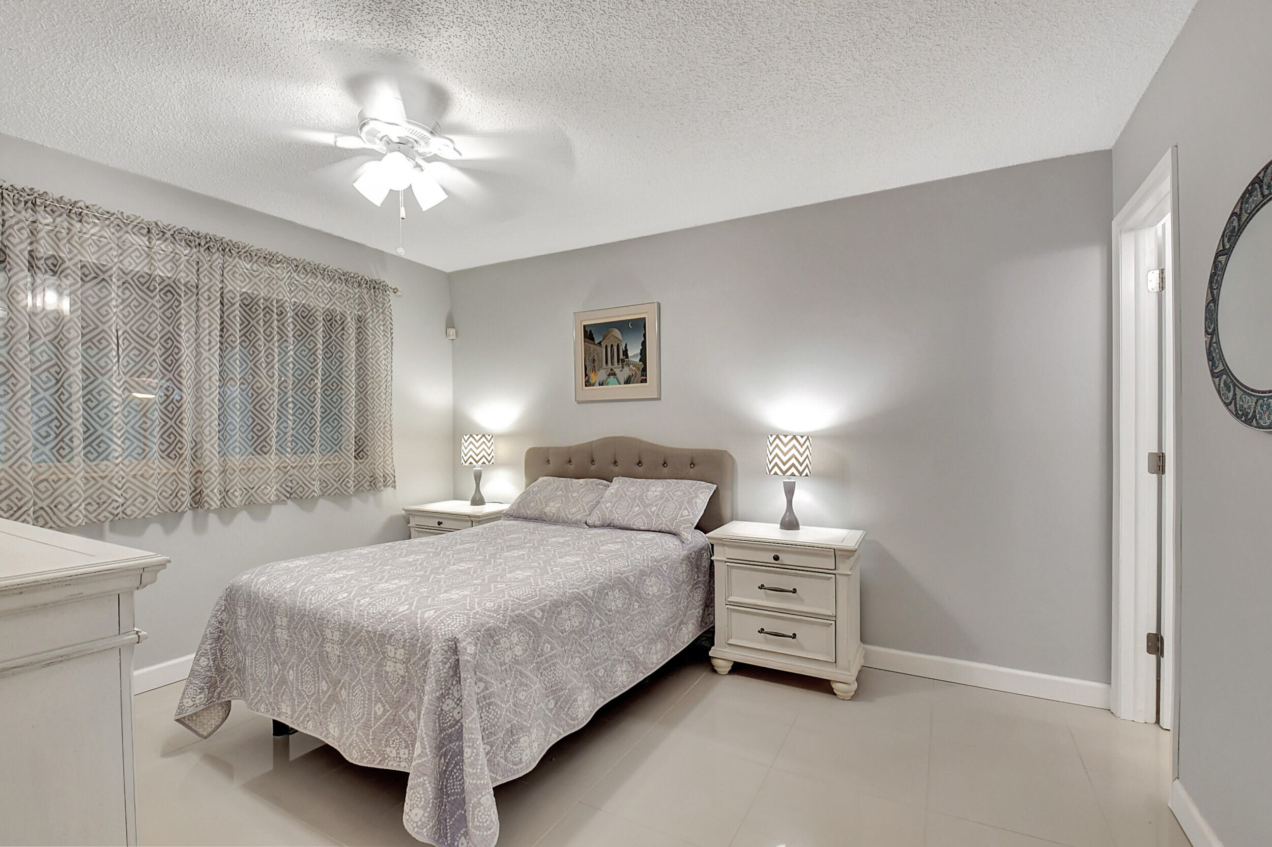 14520 Lucy Drive Delray Beach, FL 33484 - Photo 19 of 63 a bedroom with a bed and a chandelier