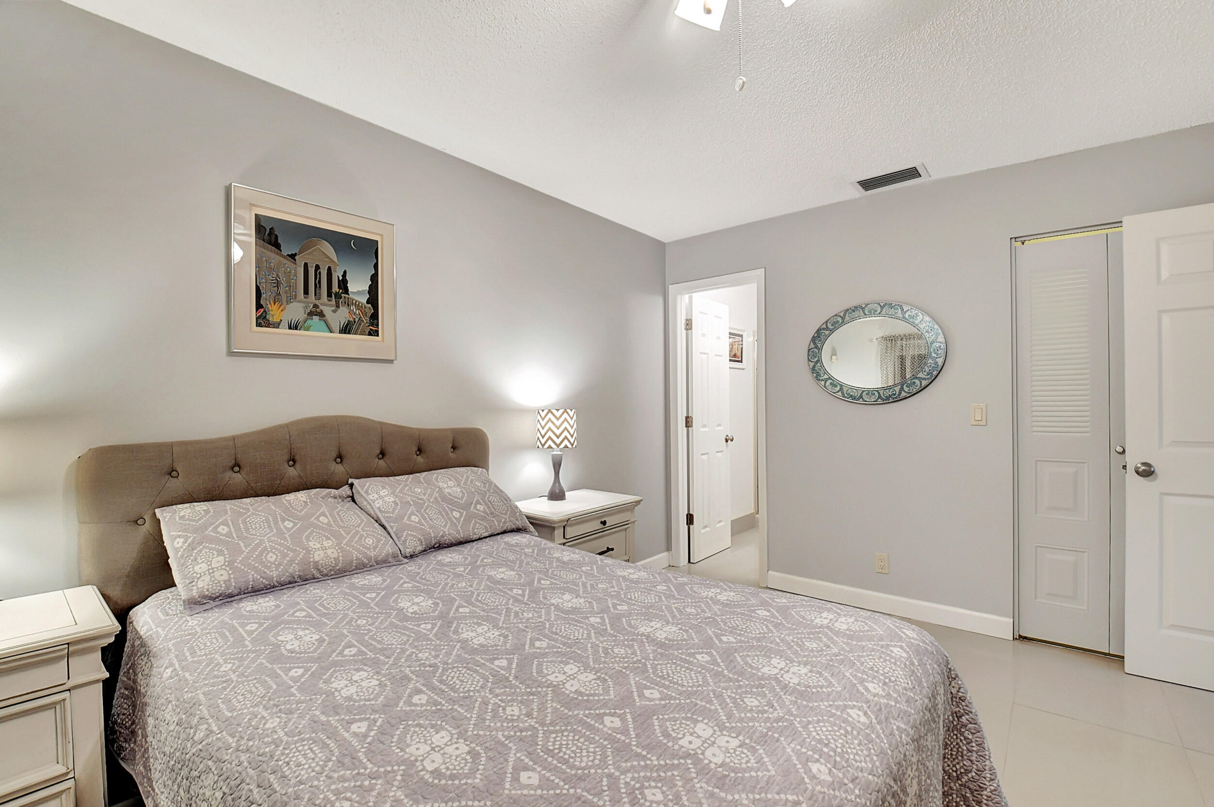 14520 Lucy Drive Delray Beach, FL 33484 - Photo 21 of 63 a bedroom with a bed and a large mirror