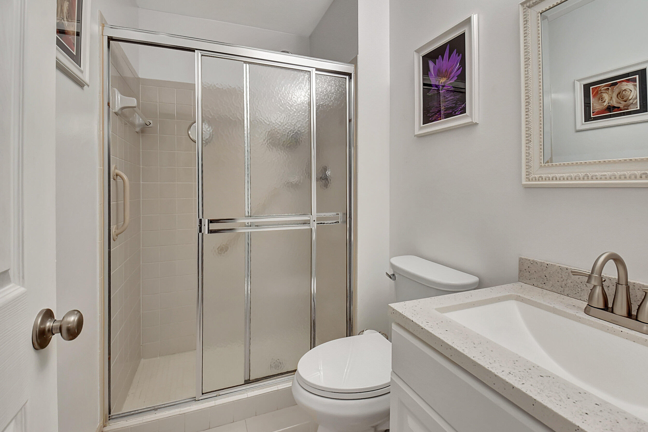 14520 Lucy Drive Delray Beach, FL 33484 - Photo 22 of 63 a bathroom with a toilet sink vanity and shower