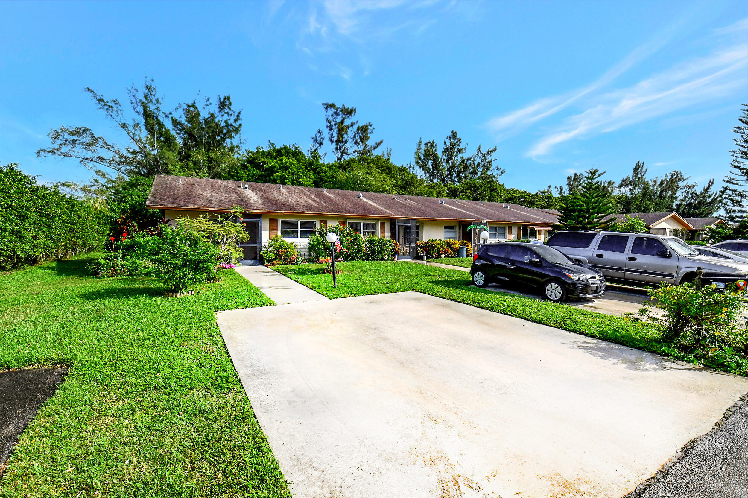 14520 Lucy Drive Delray Beach, FL 33484 - Photo 30 of 63 a view of yard with outdoor seating and green space