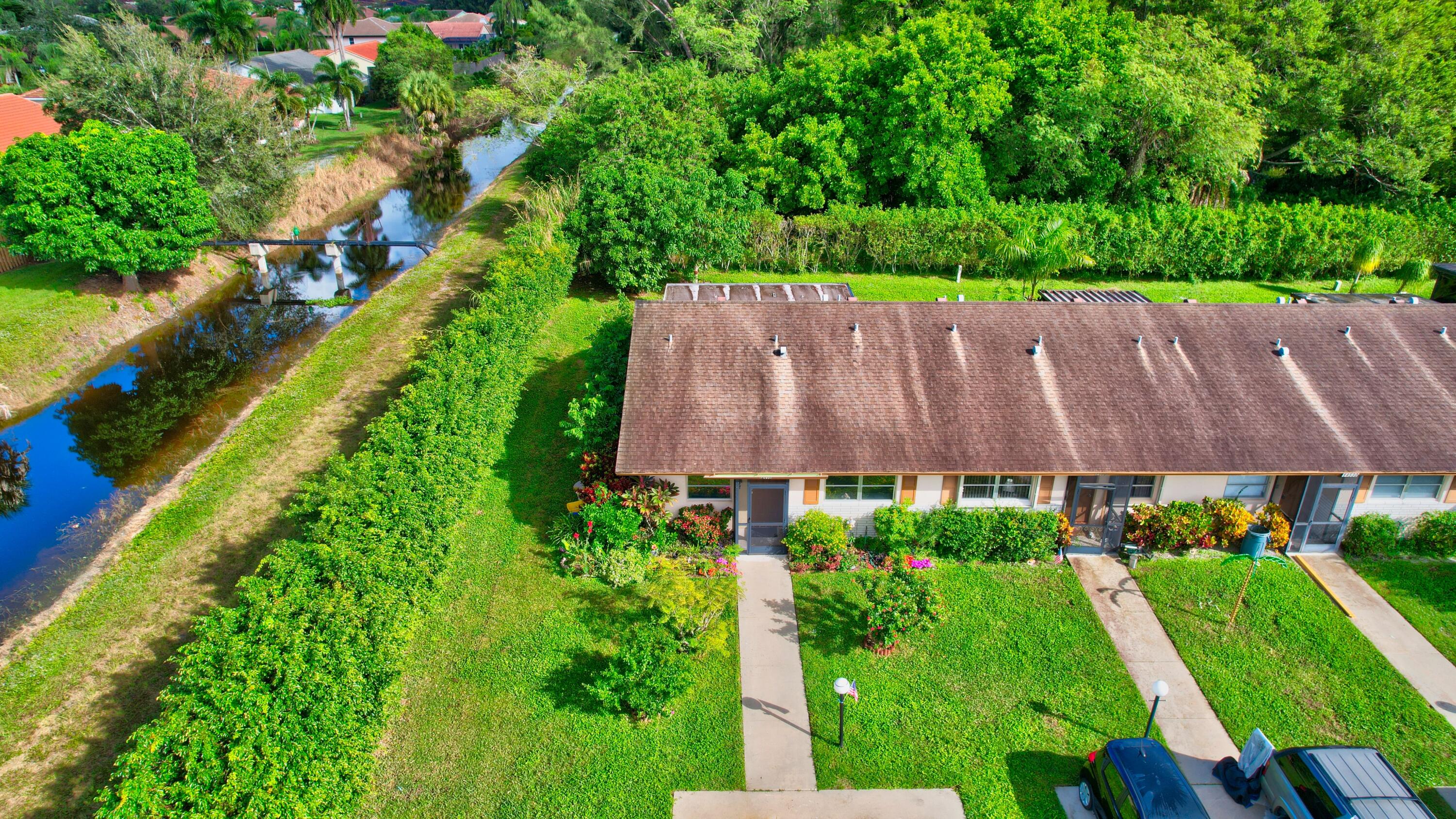 14520 Lucy Drive Delray Beach, FL 33484 - Photo 31 of 63 a aerial view of a house with a yard and a garden