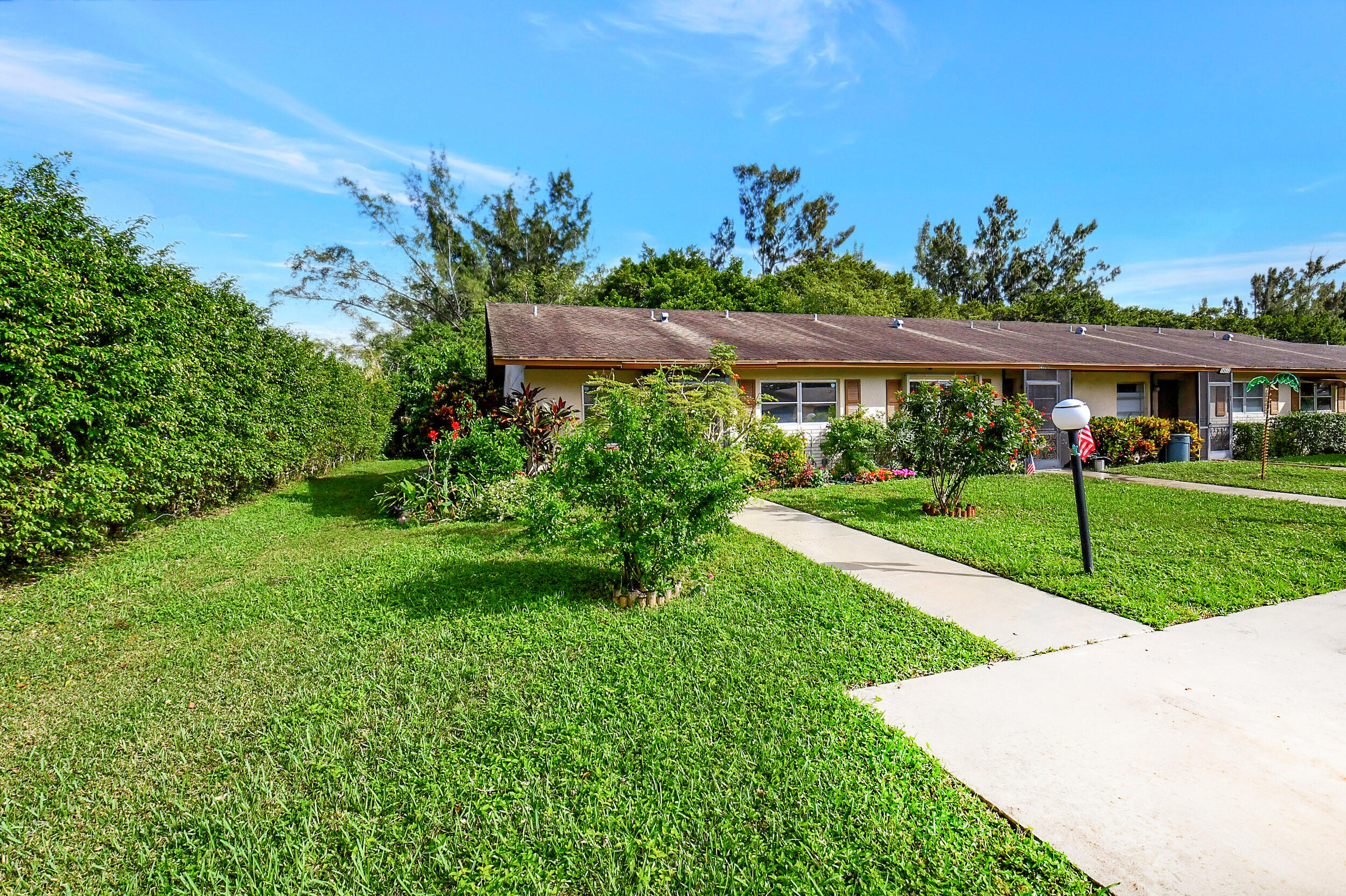 14520 Lucy Drive Delray Beach, FL 33484 - Photo 4 of 63 a view of a garden with a flower in a garden