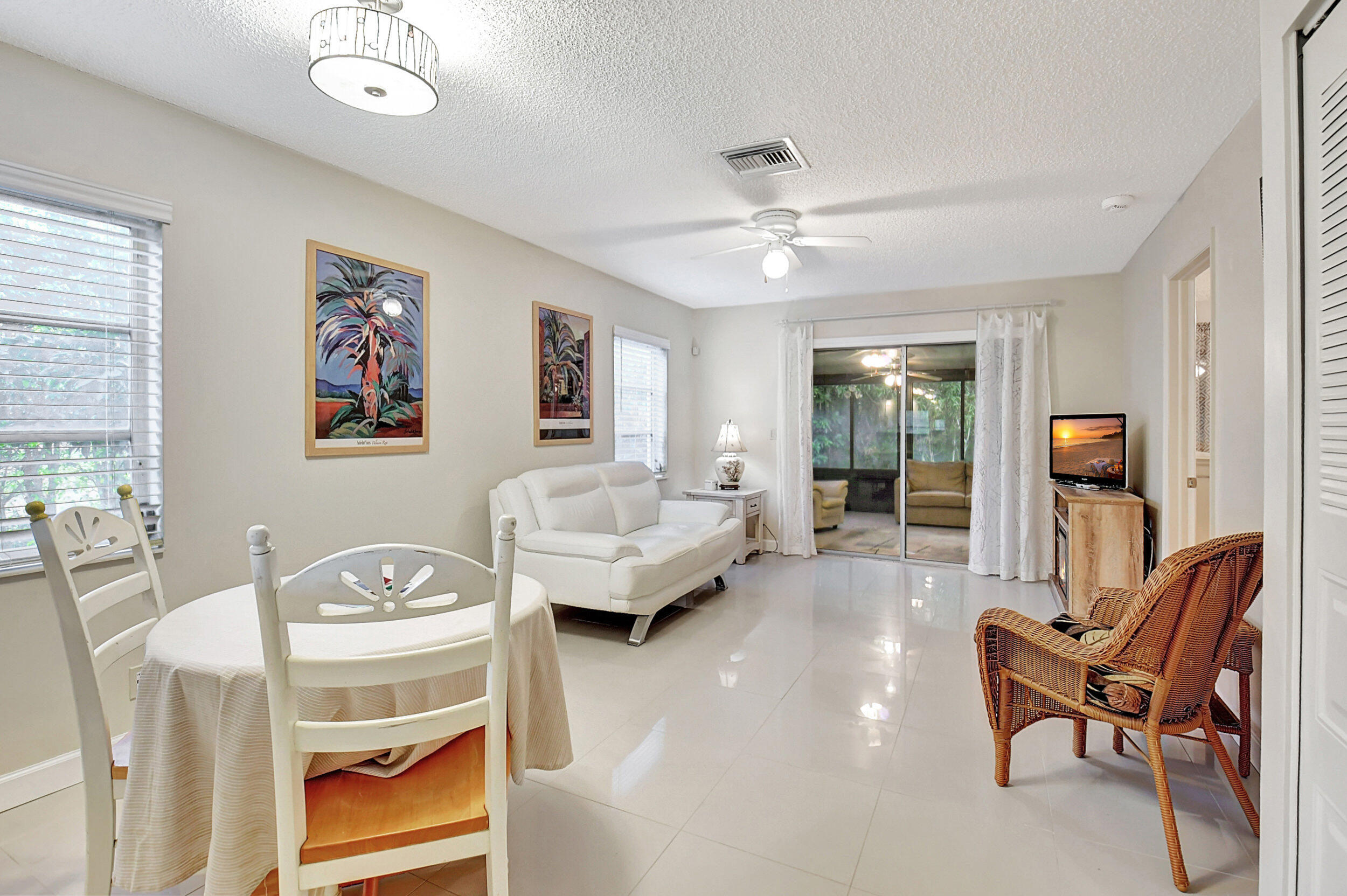 14520 Lucy Drive Delray Beach, FL 33484 - Photo 5 of 63 a living room with furniture and a chandelier