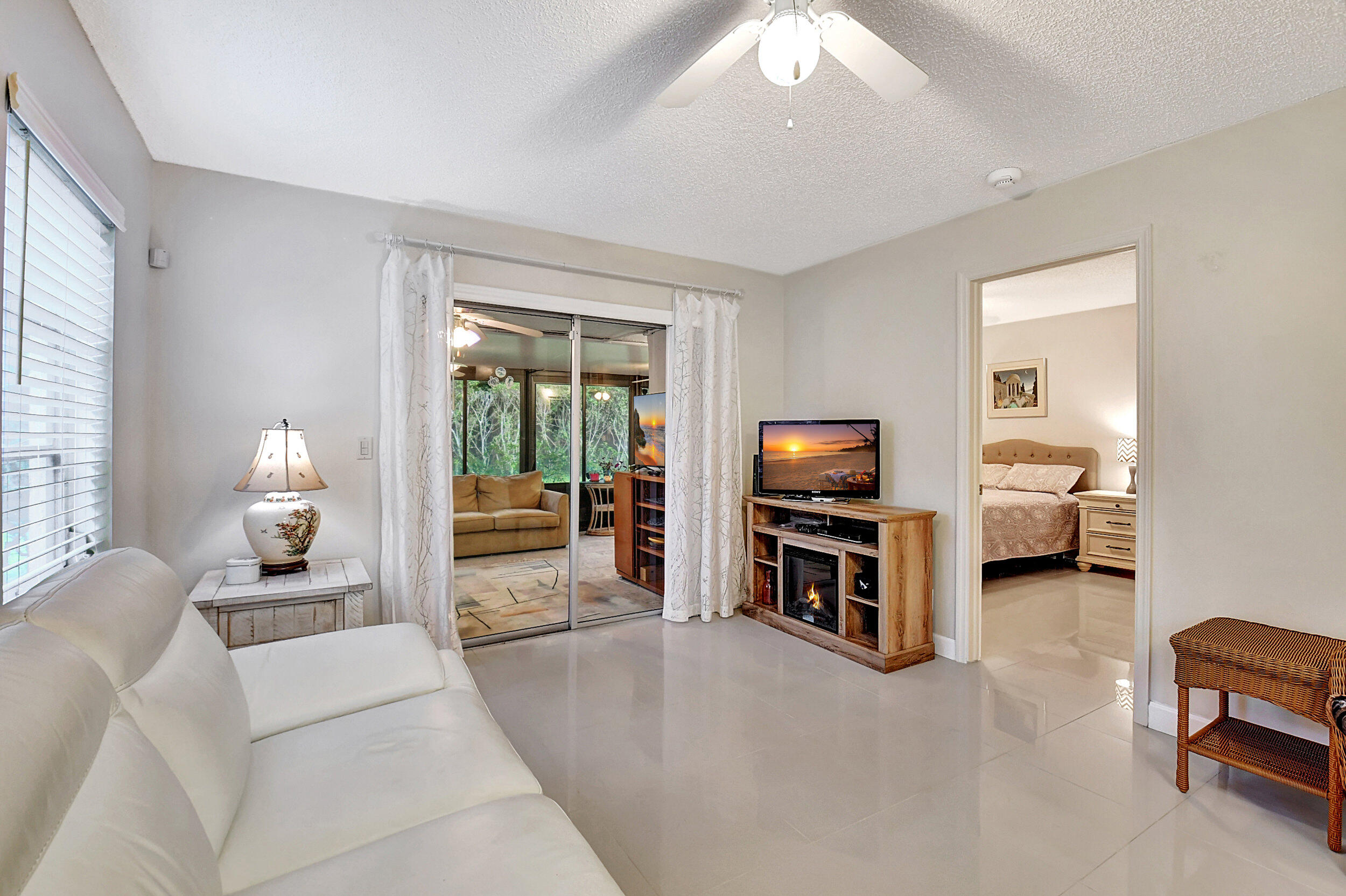 14520 Lucy Drive Delray Beach, FL 33484 - Photo 9 of 63 a living room with furniture and a flat screen tv