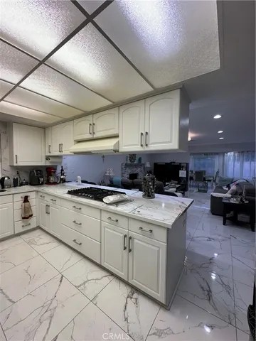 a kitchen with stainless steel appliances granite countertop a sink and cabinets