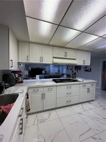 a kitchen with cabinets a sink and appliances