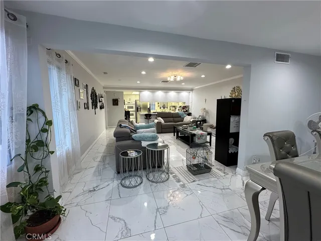 a living room with lots of furniture and clutter