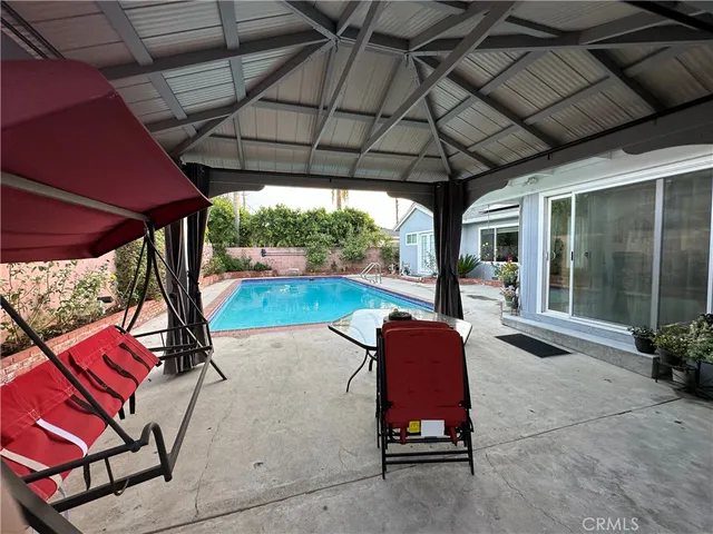 a patio with a table and chairs under an umbrella