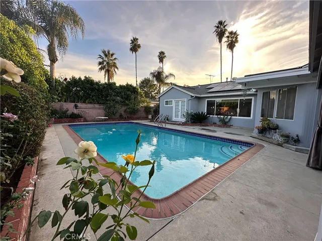 a view of a house with swimming pool and porch