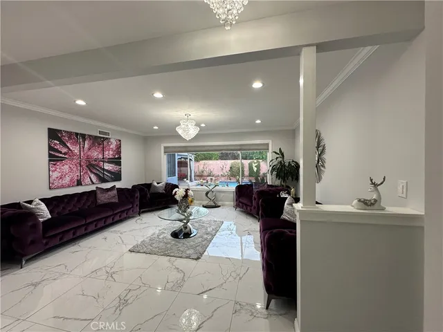 a living room with furniture gym equipment and a chandelier