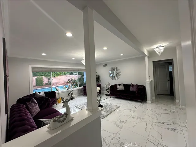 a living room with furniture a couch and a large window