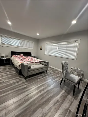 a bedroom with a bed and a chair