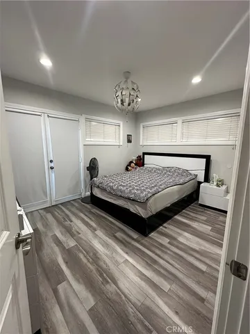 a spacious bedroom with a bed and window