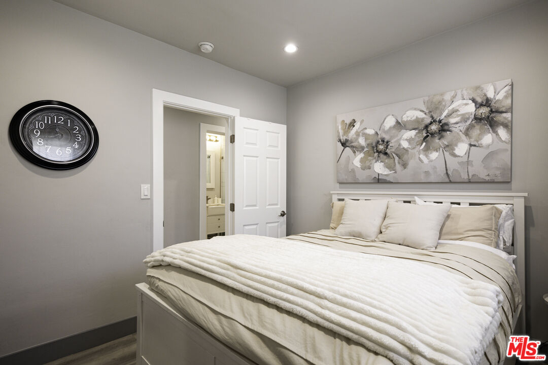 1559 1/2 South Harvard Boulevard Los Angeles, CA 90006 - Photo 12 of 16 a bedroom with a bed and a painting on the wall