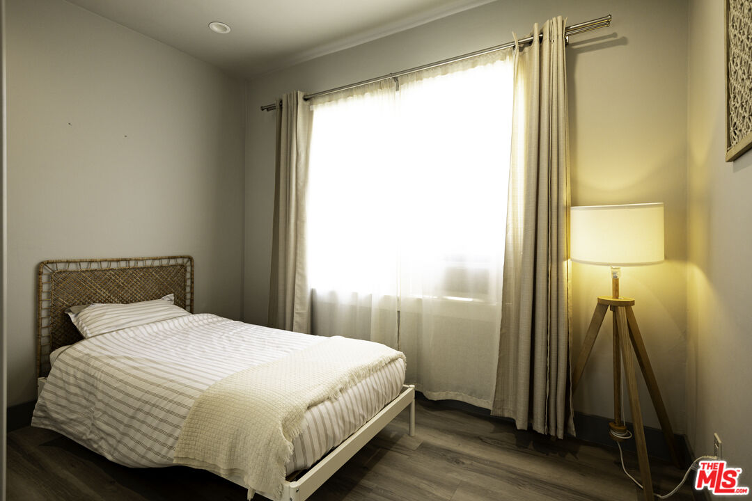 1559 1/2 South Harvard Boulevard Los Angeles, CA 90006 - Photo 14 of 16 a bedroom with a bed and a window