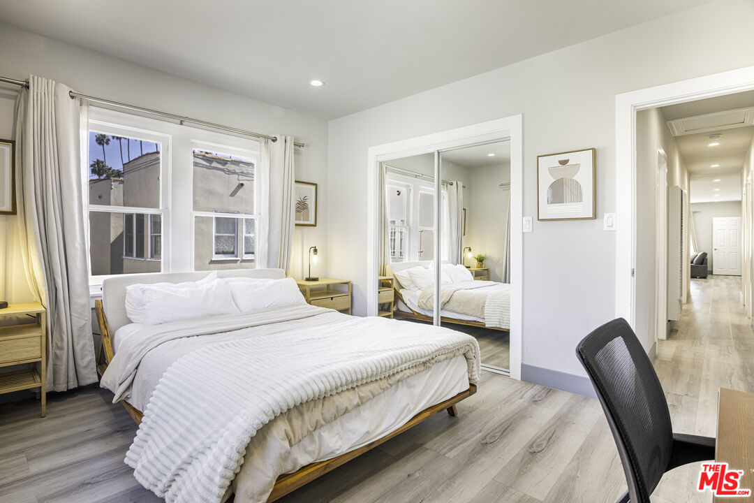 1559 1/2 South Harvard Boulevard Los Angeles, CA 90006 - Photo 9 of 16 a bedroom with a large bed and a large window