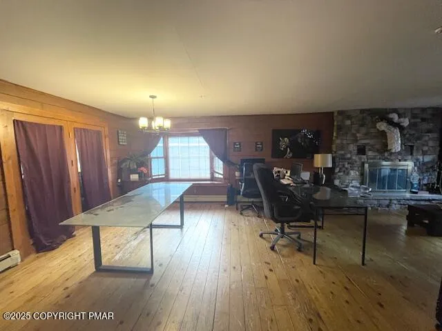 a view of a workspace with furniture and wooden floor