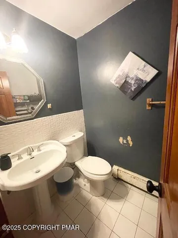 a bathroom with a sink a toilet and mirror