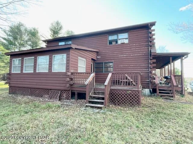 a view of a house with a bed and wooden fence