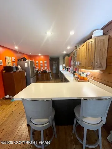 a kitchen with a table chairs and a kitchen