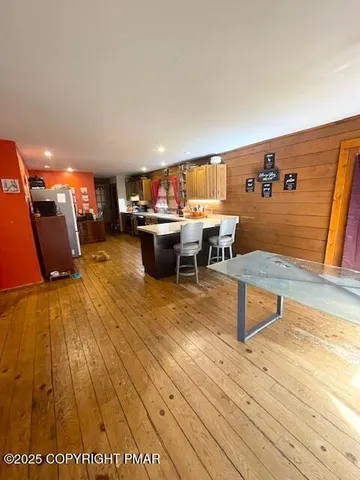 a living room with furniture a rug and a table