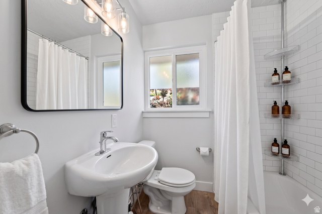 7879 Oak Street Midvale, UT 84047 - Photo 14 of 32 Bathroom featuring a pedestal sink, chrome fixtures, and a rectangular mirror with an overhead light bar