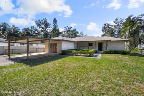 a view of a house with backyard porch and sitting area