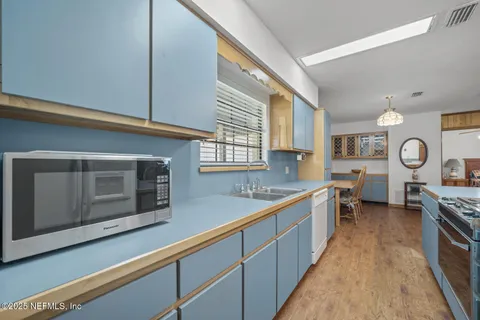 a kitchen that has a stove and a table in it