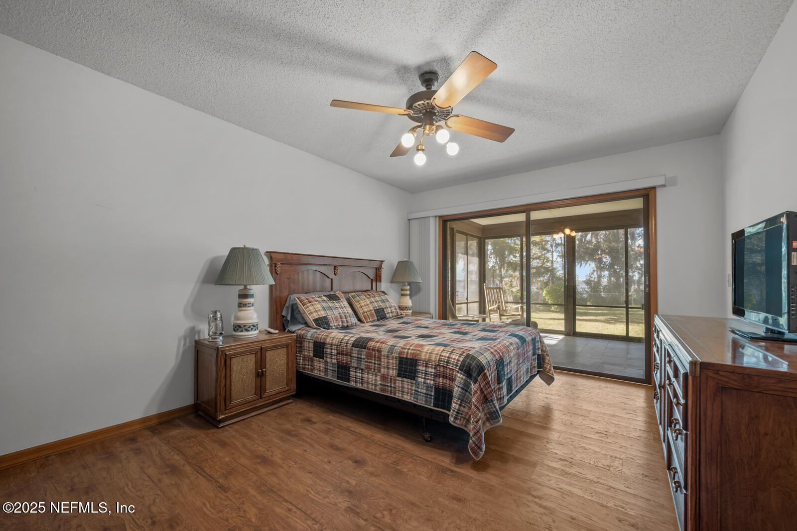 6365 Jack Wright Island Road St. Augustine, FL 32092 - Photo 21 of 53 a bedroom with a bed and a flat screen tv