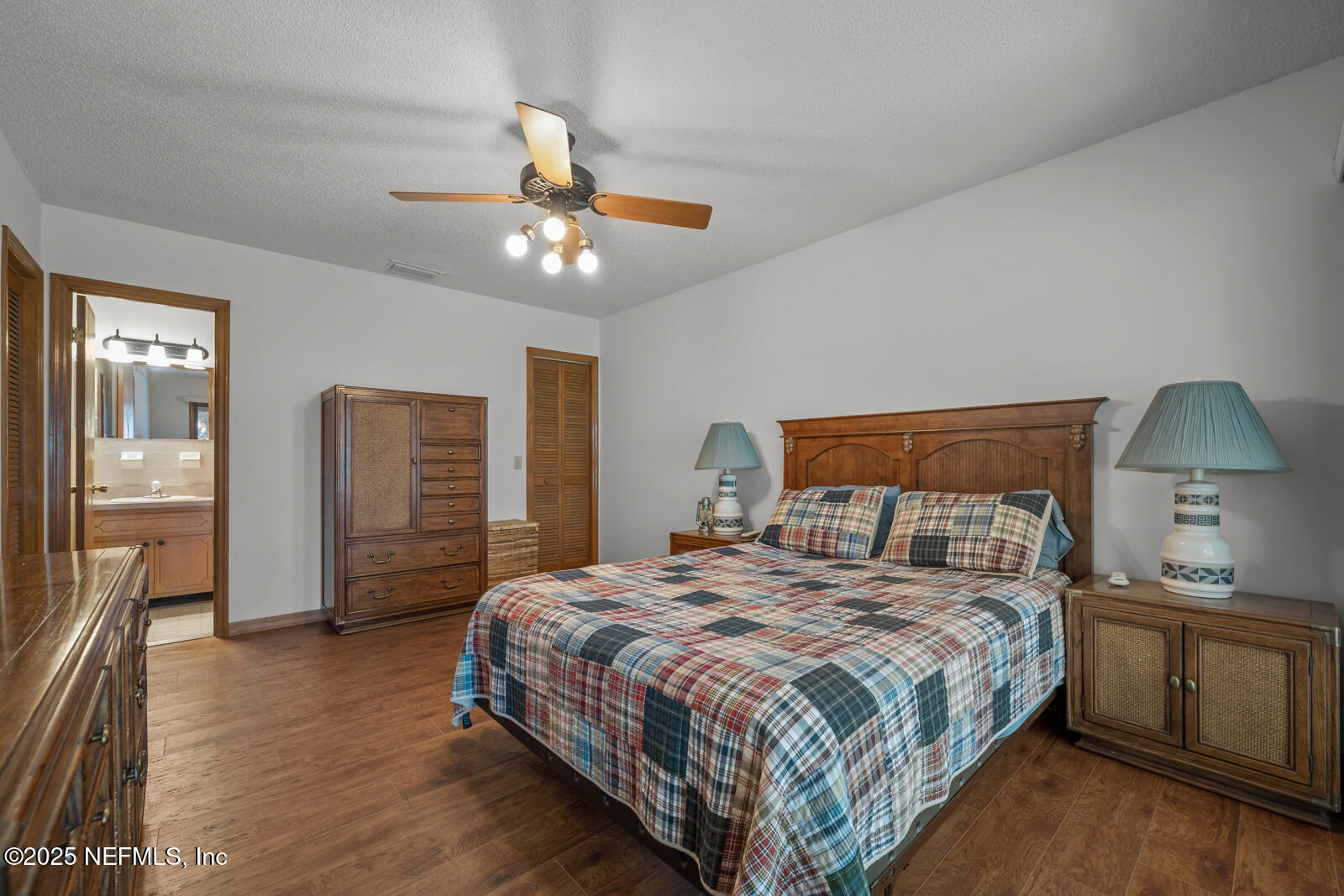 6365 Jack Wright Island Road St. Augustine, FL 32092 - Photo 22 of 53 a bedroom with a bed ceiling fan and a wooden floor