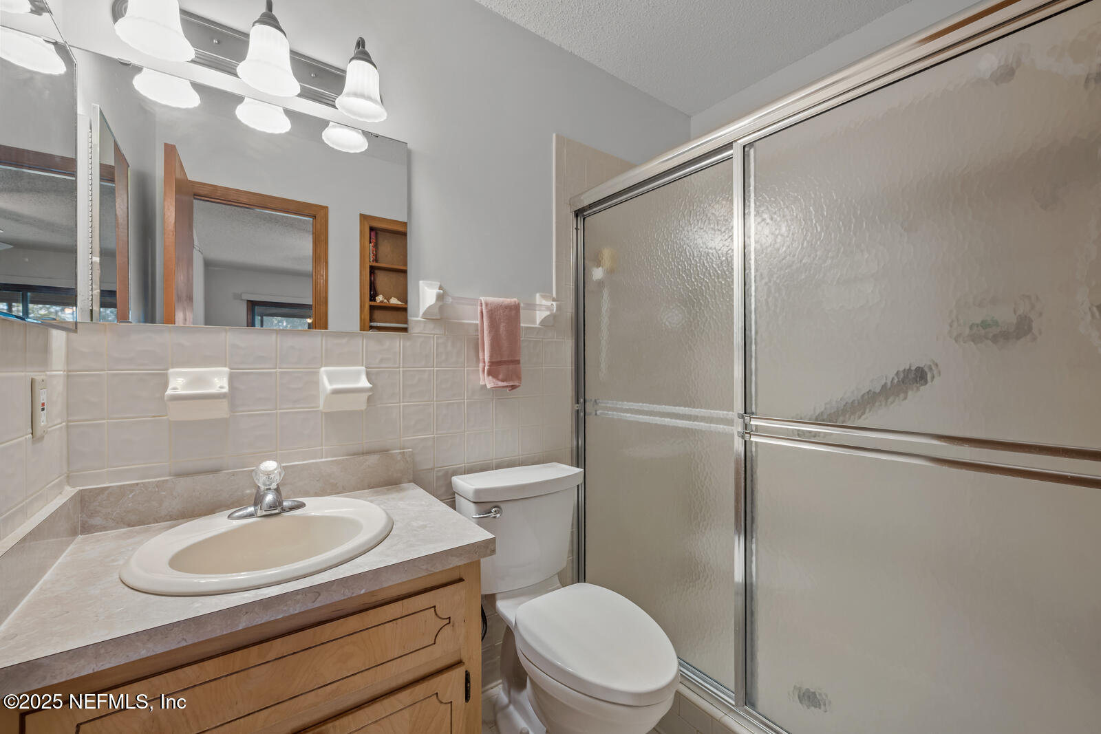 6365 Jack Wright Island Road St. Augustine, FL 32092 - Photo 23 of 53 a bathroom with a sink a toilet and a mirror