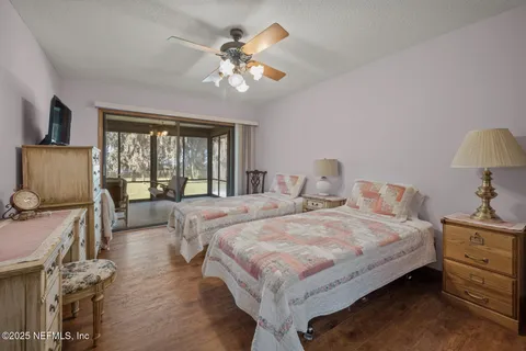 a spacious bedroom with a bed and a chandelier