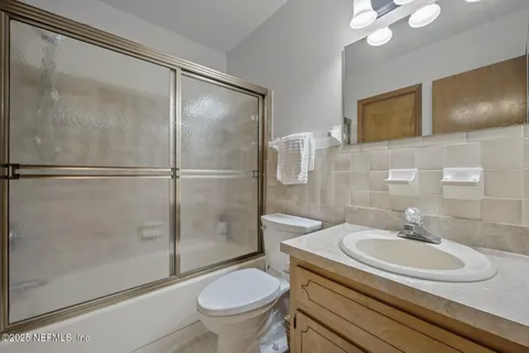 a view of a dining room with furniture wooden floor and a chandelier