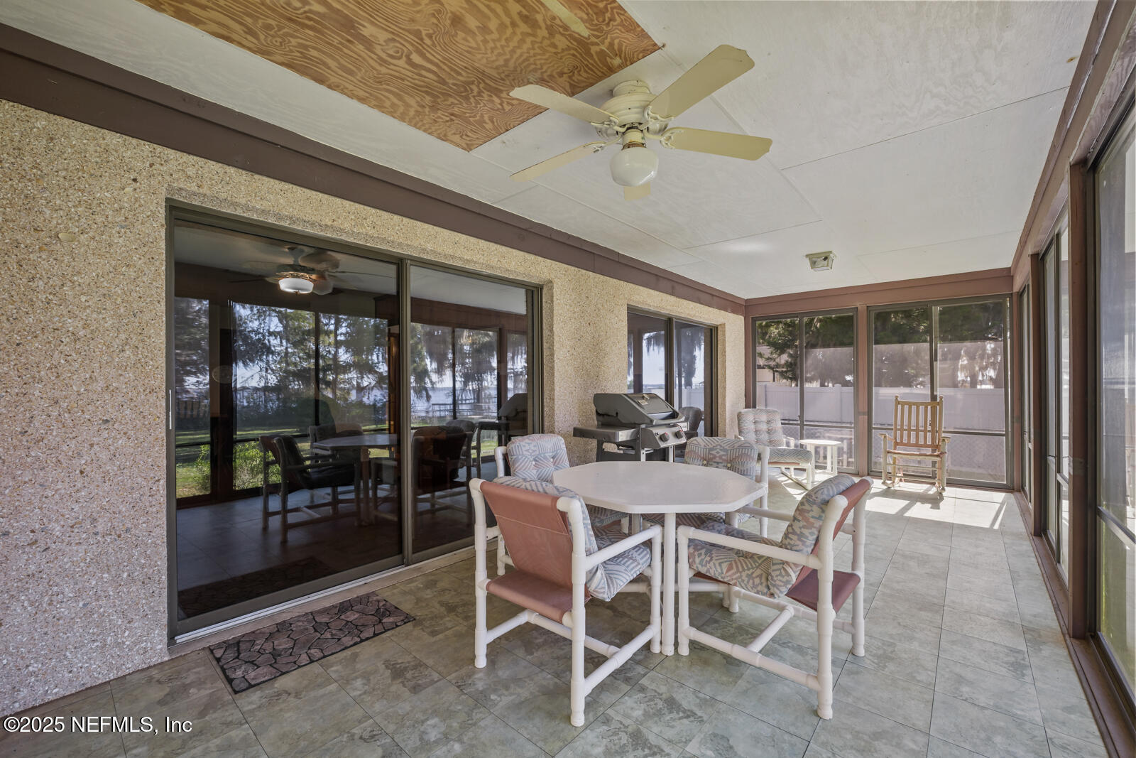 6365 Jack Wright Island Road St. Augustine, FL 32092 - Photo 27 of 53 a view of a dining room with furniture wooden floor and a chandelier