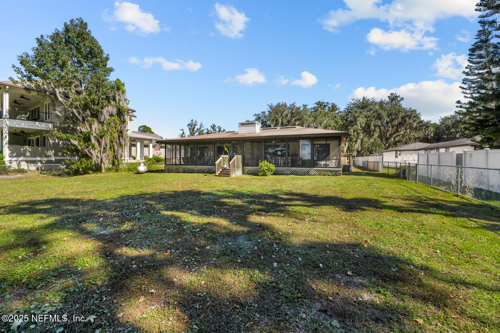 6365 Jack Wright Island Road St. Augustine, FL 32092 - Photo 33 of 53 a view of a house with a big yard and large trees