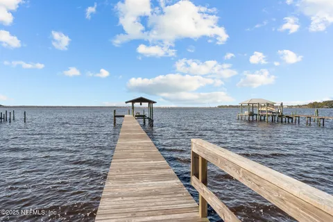a view of a balcony with wooden floor and outdoor seating