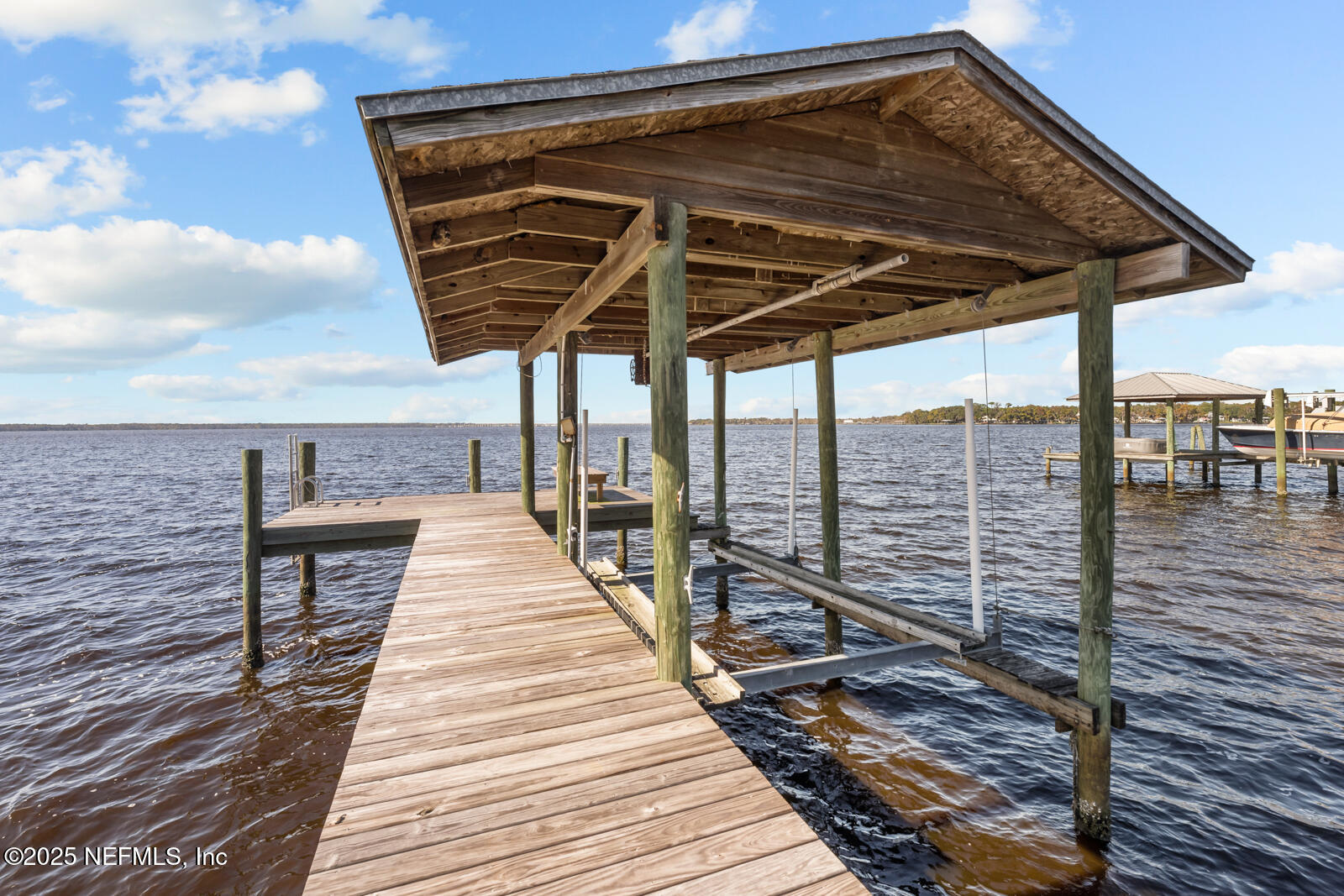 6365 Jack Wright Island Road St. Augustine, FL 32092 - Photo 37 of 53 a view of a balcony with wooden floor and outdoor seating