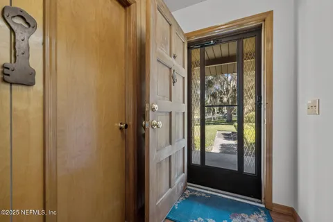 a hallway with closet and wooden floor