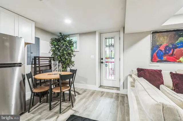 a dining room with furniture and a refrigerator
