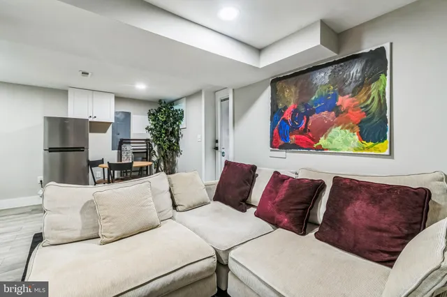 a living room with furniture and kitchen view
